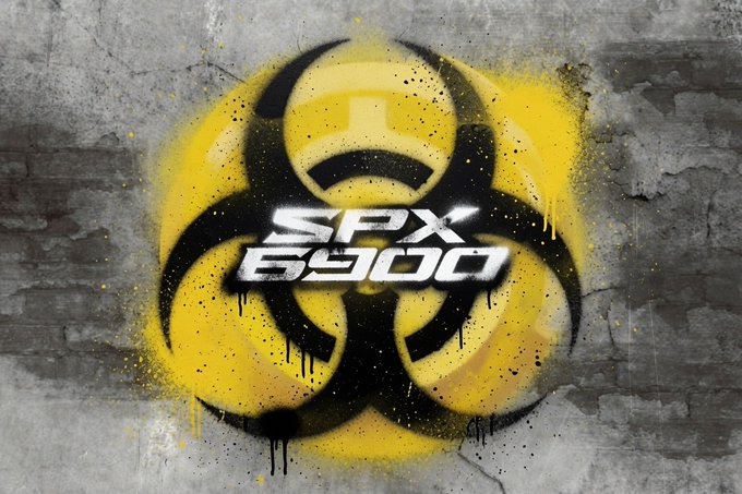 A graffiti-style graphic featuring a yellow and black biohazard symbol with the text 'SPX 6900' spray-painted on a gray brick wall.