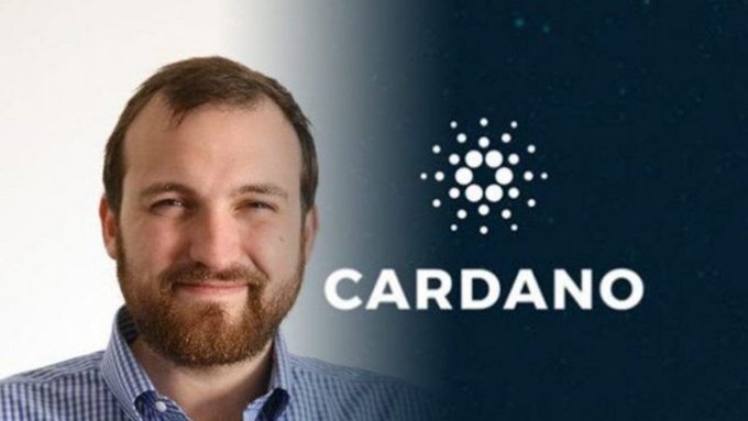 The image shows a smiling man with a beard wearing a blue checkered shirt, positioned alongside the Cardano logo (featuring its distinctive dot-pattern emblem) and the word "CARDANO" on a dark gradient background. This appears to be Charles Hoskinson, the founder of Cardano, whose image accompanies the news about Cardano climbing to #2 in active developers ahead of Solana.