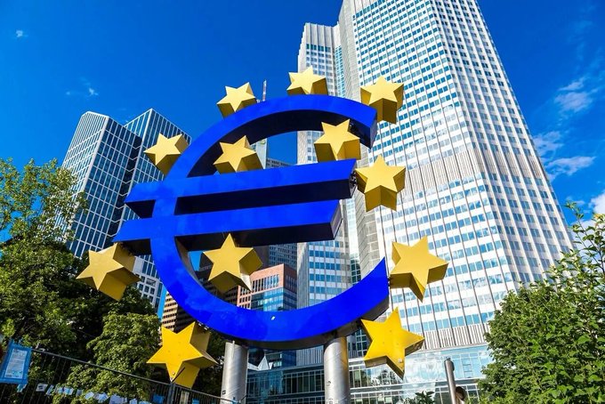 The iconic Euro sculpture stands prominently in front of modern skyscrapers in Frankfurt's financial district, symbolizing the European Central Bank's monetary policy decisions. The image visually anchors the post's discussion of the ECB holding interest rates steady at 2.25%, with the euro symbol serving as a direct reference to the central bank setting the stage for potential future rate cuts that could benefit risk assets like Bitcoin.