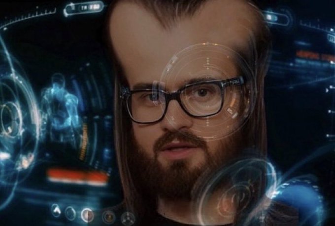 A composite image blending the face of actor Seth Rogen wearing black glasses with a futuristic, sci-fi heads-up display (HUD) featuring blue glowing graphics, holograms, and a targeting reticle over his eye.