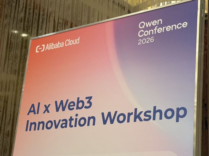 The image features a large sign that reads "Qwen Conference Singapore, Alx Web3 Innovation Workshop" with a purple background and white text. The sign also includes information about an upcoming workshop at the Qwen Conference.