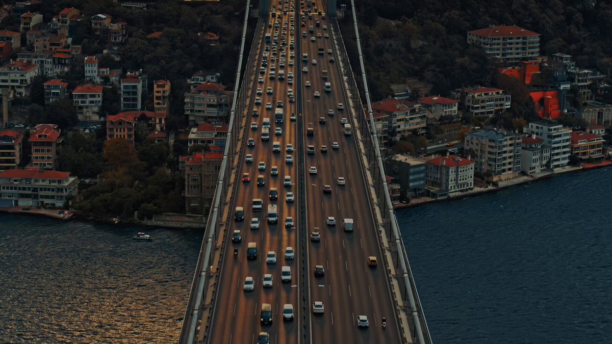 The image shows a cityscape with a large bridge spanning across a river, surrounded by buildings of various sizes. The scene captures traffic moving along the bridge, indicating that it's an active area for transportation. The caption provided seems unrelated to the image itself or the bridge, and there is no clear connection between the image and the post about credit markets.