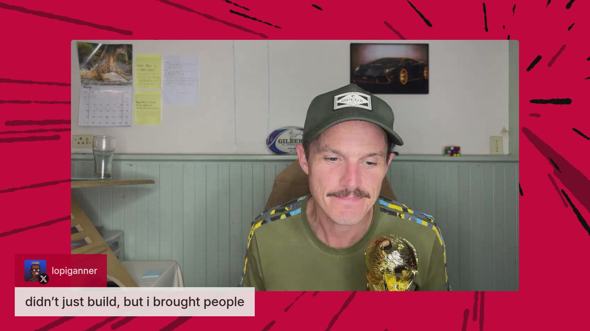 The image shows a man wearing a green shirt holding up an award with gold lettering that says "SUPRA" above his head. The background of the image features a red frame with white lines, and there are yellow sticky notes on the wall behind him. A caption below the image reads "We're live right now! Join us for an evening beverage, and you could win !"