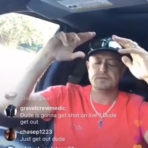 The image shows a man wearing an orange shirt, sitting inside a car with his hands raised up. He appears to be adjusting or putting something on his head while driving. The caption of the image reads "full moon sunday". This suggests that the photo was taken during the weekend when people tend to spend more time outdoors and engage in leisure activities like hanging out at home, watching movies, or going for a drive with friends.