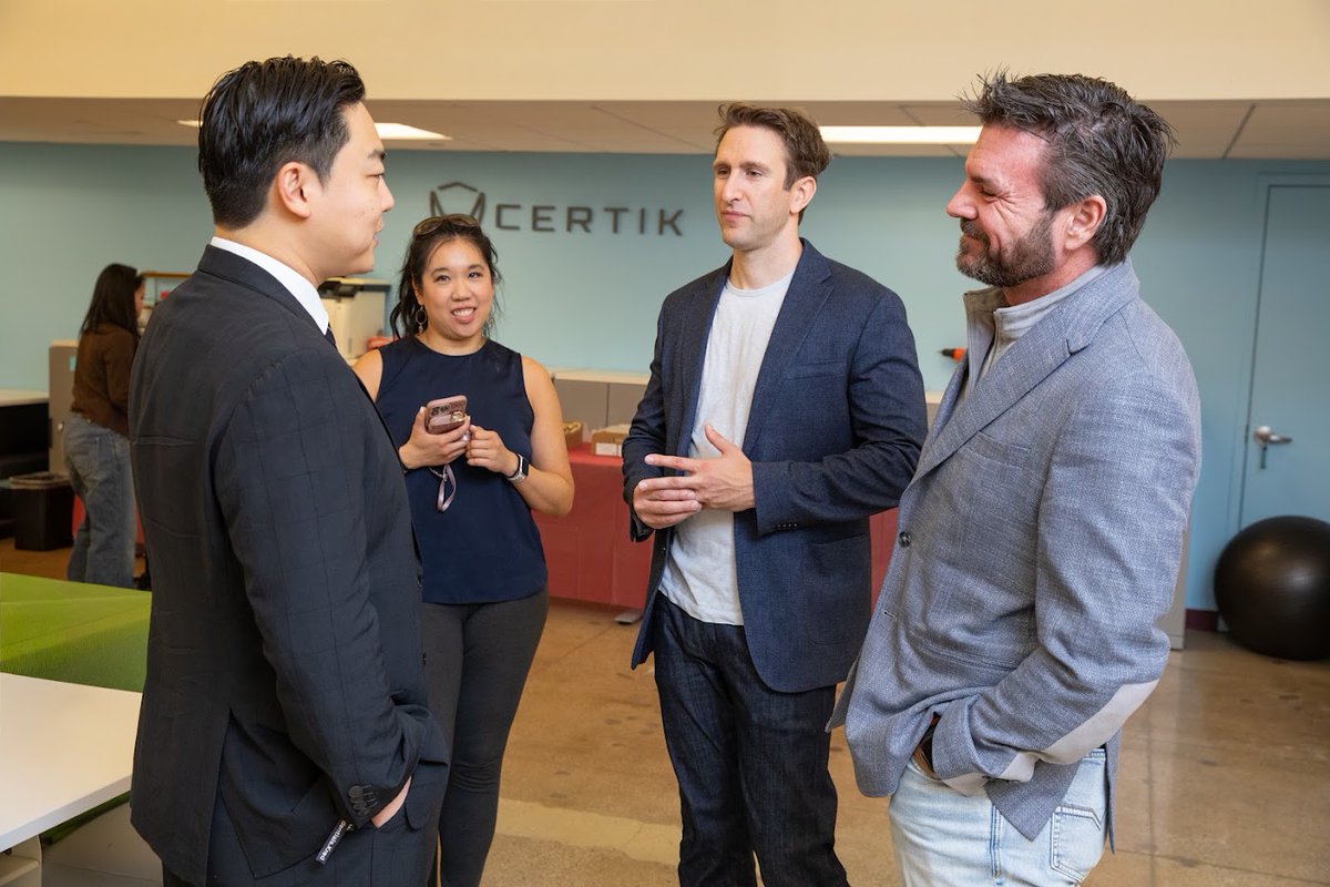 Four professionals engage in conversation at the Certik NYC Open House, with the "CERTIK" logo visible on the wall behind them, reflecting the networking and discussion highlighted in the accompanying post about NFT NYC.