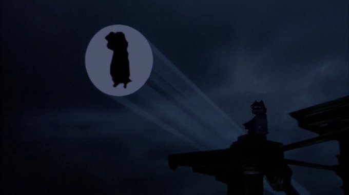 llorwe, a bat-like creature with wings and a tail, soars through the night sky, accompanied by a large white circle of light.
