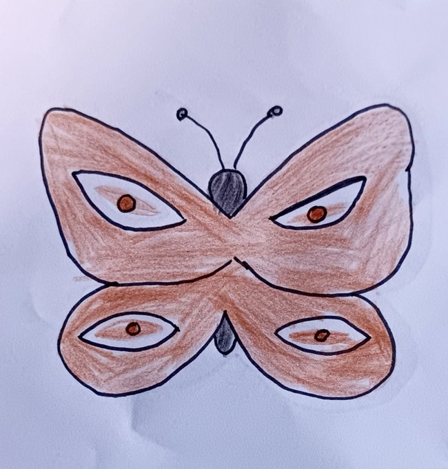 Child's crayon drawing of a butterfly with four eye-spots on its orange-brown wings, a dark gray body, and two antennae on white paper.