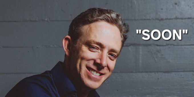 The image shows a smiling man with short brown hair wearing a dark blue shirt, posed against a gray concrete wall. The word "SOON" appears in large white quotes to the right, visually emphasizing the "$ICP" (Internet Computer) hype referenced in the post, which plays on the meme that crypto projects promising future developments always say "soon."