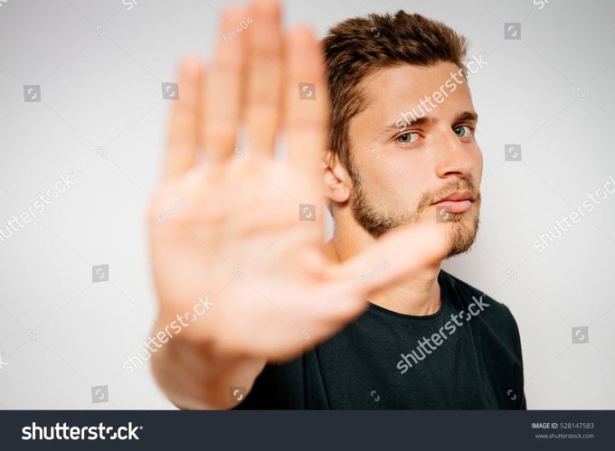 A young man with a beard holds his palm up toward the camera in a "stop" gesture while looking off to the side with a tense, conflicted expression, visually representing the hesitation or second-guessing a trader might feel after an unexpected windfall. The image pairs with a post about a trader profiting $324,000 from a small $37 investment, capturing the disbelief of such an improbable financial outcome.