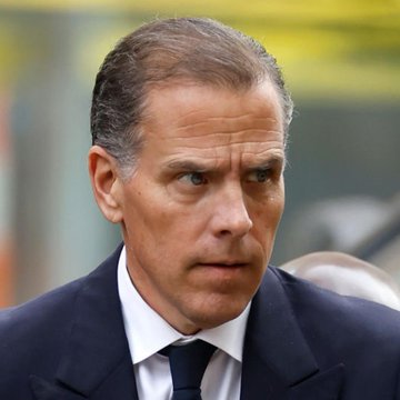 A close-up shows Hunter Biden with a serious, focused expression, wearing a dark suit and tie, apparently arriving at or attending a formal event. The image pairs with news that he has released forensic accounting from his laptop regarding the "$LAPTOP" memecoin, alleging that two market makers extracted approximately $2.87 million as the token's value plummeted around 98% on its launch day.
