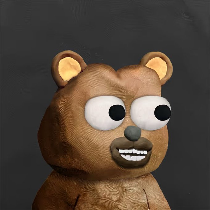 A 3D-rendered brown teddy bear character with large googly eyes, a prominent black nose, and a wide toothy grin against a dark gray background.