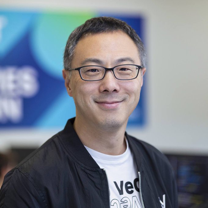 A man with glasses, identified as Sunny Lu, founder of VeChain ($VET), smiles in a portrait while wearing a t-shirt partially visible reading "Vec..." (VeChain), visually connecting him to the crypto coin highlighted in the post about VeChain's link to Louis Vuitton.