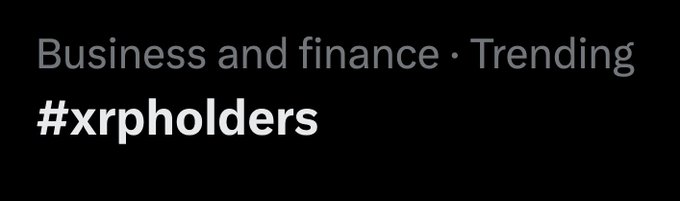 The image displays a black background with the text "Business and finance · Trending" followed by the hashtag "#xrpholders" in bold white lettering, indicating that XRP holders are currently a trending topic in business and finance discussions, likely tied to recent developments or news surrounding the XRP cryptocurrency community.