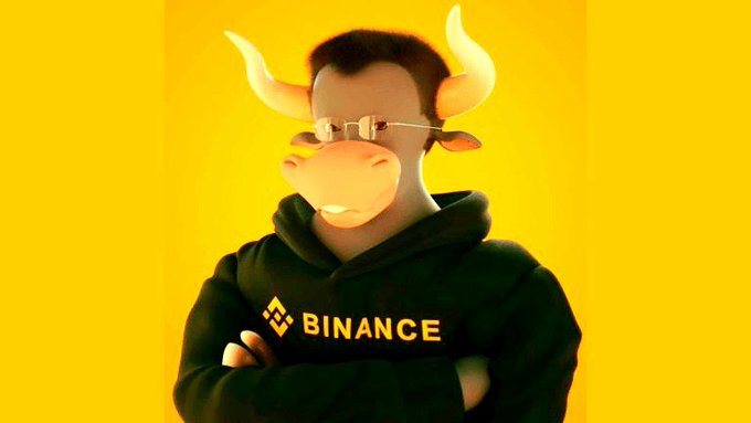 A figure wearing a bull/cow mask and a black Binance hoodie stands with crossed arms against a yellow background.