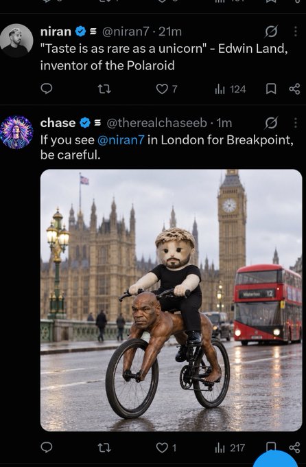 A Twitter screenshot showing a tweet from chase (@therealchaseeb) replying to @niran7, featuring an AI-generated image of a muscular man with a teddy bear head riding a bicycle in London near Big Ben, captioned 'If you see @niran7 in London for Breakpoint, be careful.'