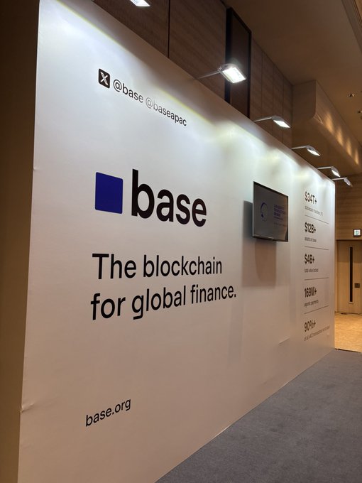 A large illuminated billboard at a Base event displays 'base - The blockchain for global finance' with the @base handle and base.org URL.