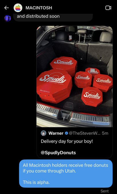 A screenshot of a Twitter DM conversation showing a delivery of multiple red 'Spudly' branded boxes loaded in a car trunk, with a reply stating 'All Macintosh holders receive free donuts if you come through Utah.'