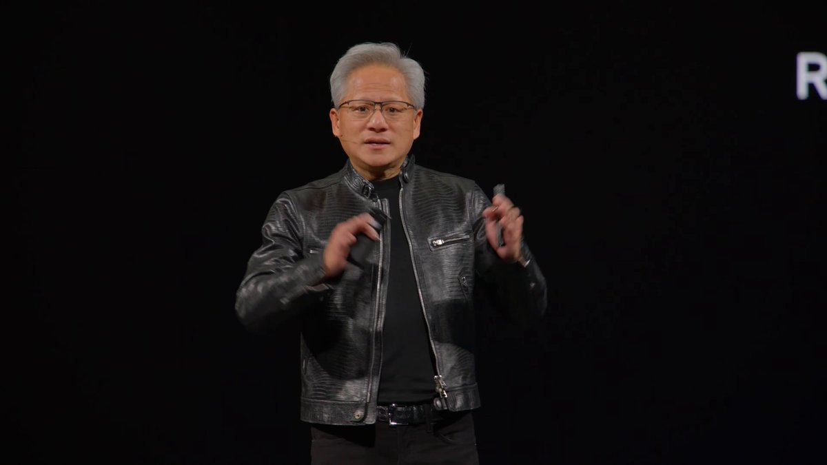 The image features an older man wearing a black leather jacket, standing in front of a black background. He appears to be giving a speech or presentation, as indicated by his body language and facial expressions. The caption provided seems unrelated to the main subject matter but includes some additional information about Blender/Octane and Render network.