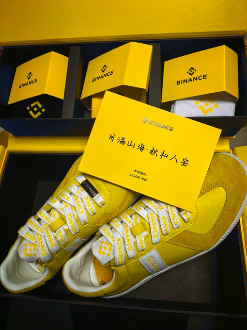 A pair of yellow Binance-branded sneakers and shoeboxes are displayed alongside a card inscribed with "闭涛山海·秋和人安" (dated 2024年•中秋), the Binance team wishing for smooth, prosperous journeys in celebration of the Mid-Autumn Festival.