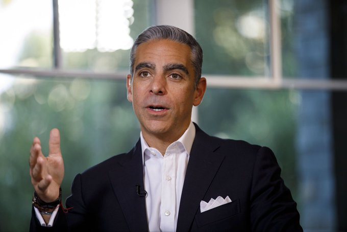 A well-dressed man with graying hair, wearing a dark suit and white shirt, gestures with his right hand while speaking during what appears to be an interview, with a blurred window background behind him. The image relates to the post by depicting a public figure—likely a former PayPal executive—making a bold statement advocating for the U.S. to liquidate its gold reserves in favor of Bitcoin as a superior store of value.