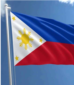 The national flag of the Philippines waving against a blue sky with clouds, featuring a white triangle with a yellow sun and stars, alongside blue and red horizontal bands.