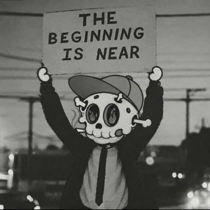 A black-and-white image of a figure with a cartoon skull and cap face holding up a sign reading 'THE BEGINNING IS NEAR' against an urban nighttime backdrop.