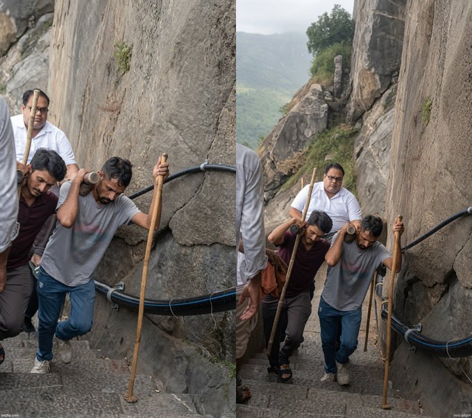 Two men trudge up a steep, rocky staircase using wooden poles for support, with a man in glasses following behind them. The image humorously illustrates the exhausting uphill battle of holding out for Bitcoin to hit $100k before quitting a day job—portraying the climb to financial freedom as a grueling, literal climb.