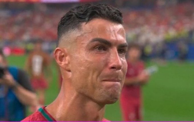 A close-up of a teary-eyed soccer player wearing a red Portugal jersey appears on a stadium field, with his emotional expression capturing a poignant moment. The image relates to the post by highlighting the player's vulnerability, suggesting that even devoted fans of his rival might feel sympathy upon witnessing such a raw display of emotion.