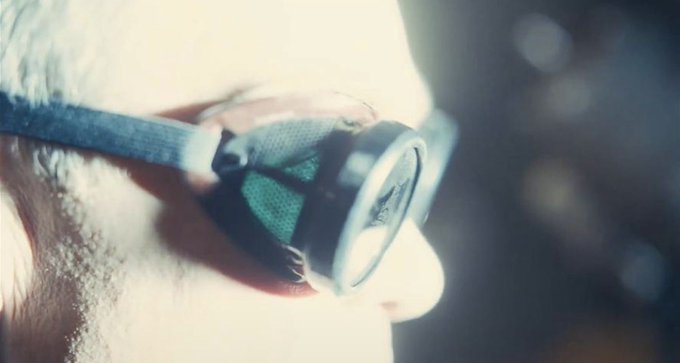 A close-up shows a person's eye wearing a specialized device, possibly a heads-up display or lens attachment, with no visible text or numbers. The image metaphorically suggests "vision" or insight, fitting the post's hint about recognizing something obvious and positioning oneself accordingly based on what one sees or foresees.