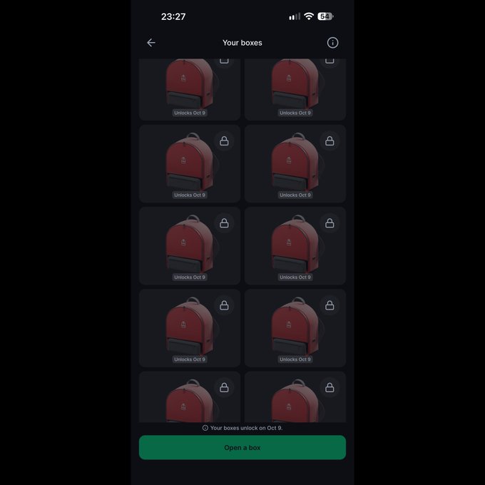 A mobile app screenshot showing a 'Your boxes' screen with a grid of red backpack icons (all locked with 'Unlocks Oct 9' labels) and a green 'Open a box' button at the bottom.