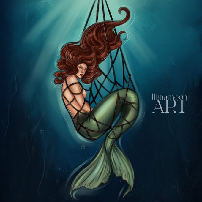 A red‑haired mermaid with a green tail is entangled in a black net underwater, looking toward the viewer. The piece is signed “Illunamoon ART” in the upper right corner.