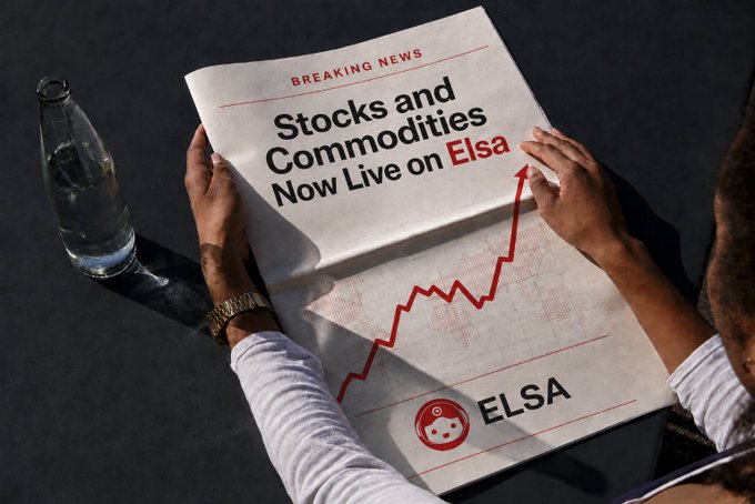 An advertisement styled as a newspaper showing 'BREAKING NEWS' that 'Stocks and Commodities Now Live on Elsa' with a rising red graph, while a person holds the paper next to a glass bottle.