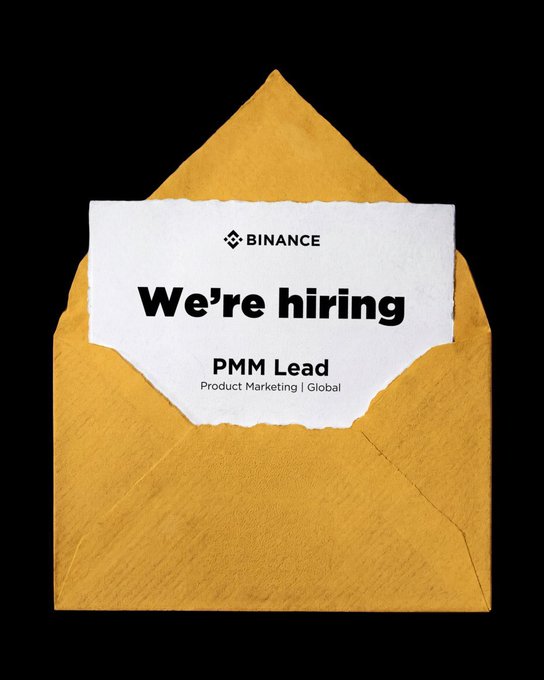 A yellow envelope on a black background containing a torn paper card with the Binance logo reading 'We're hiring - PMM Lead, Product Marketing | Global'.
