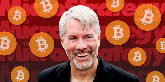 An image of Michael Saylor smiling against a red background filled with Bitcoin logos and 'MicroStrategy' text.
