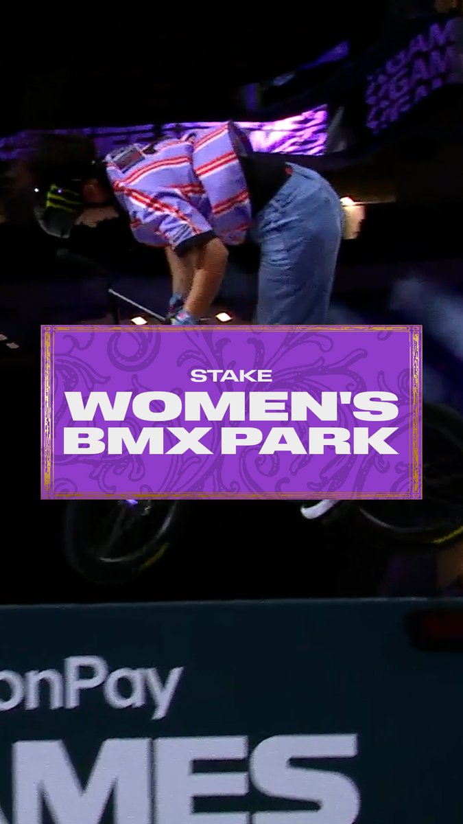 A rider in a red and white striped shirt and heavy Monster Energy cap bends over their bike, framed by a vibrant purple "STAKE WOMEN'S BMX PARK" graphic—capturing the moment Miharu Ozawa secures victory in the event at the MoonPay X Games League Championship in New Orleans.