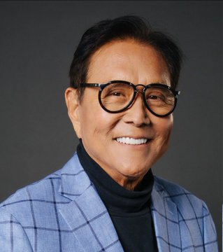 A smiling older man with glasses, wearing a blue plaid blazer over a black turtleneck, is pictured in a professional headshot. The image accompanies the caption identifying him as Robert Kiyosaki, the "Rich Dad, Poor Dad" author, who is making a bold Bitcoin price prediction.