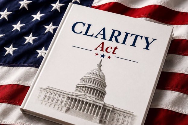 A white book titled 'CLARITY Act' featuring an image of the U.S. Capitol building rests on top of an American flag.