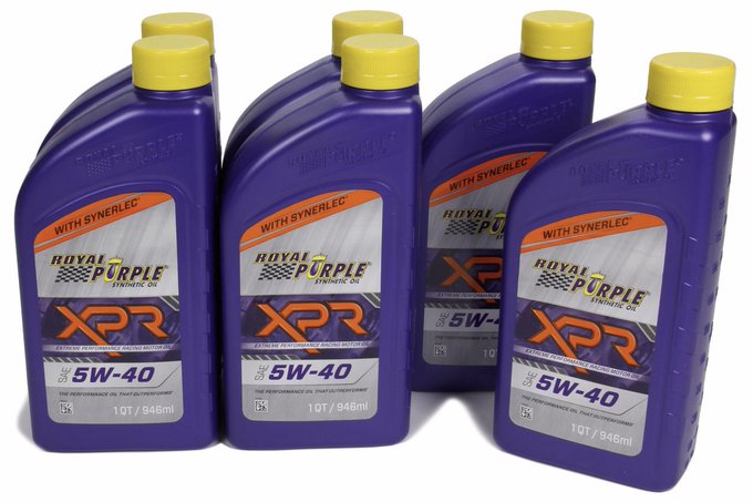 The image shows a row of six purple 5W-40 oil bottles, all identical in size and color, lined up against each other with their caps facing upwards. The text "royal purple Xpr" is visible on some of the bottles, indicating that they are from Royal Purple Oil. The bottles appear to be new and unused, as indicated by their upright position and lack of any signs of damage or wear.
