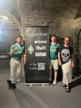 Four people posing in front of a Crypto Cells banner featuring Base, SheFi, and Anchorage Summer sponsors at 'The Great Web3 Vault' event, with one woman holding a copy of a book.