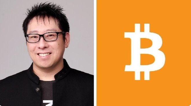 The image shows a man wearing glasses and a black jacket smiling on the left side, alongside a large white Bitcoin symbol on an orange background on the right, visually representing Samson Mow and his bullish stance on Bitcoin reaching $10 million per coin as CEO of JAN3.