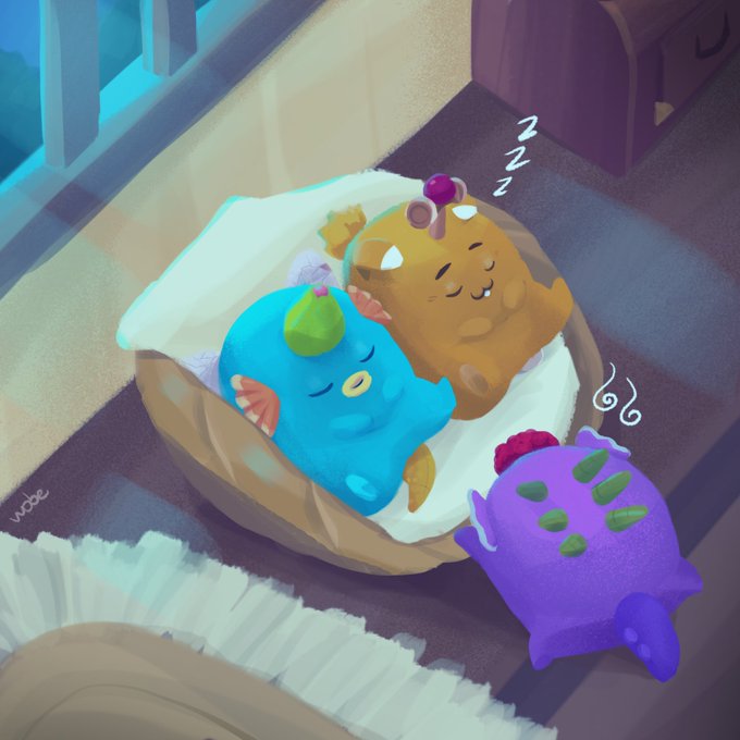 Three cute, round axolotl-like creatures (Axies) snore peacefully in a basket lined with a fluffy blanket, with a watermark reading "wobe" visible in the corner. The cozy, chibi-style illustration perfectly matches the desired wholesome Axie art aesthetic requested in the post.