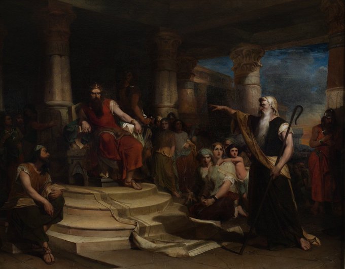 A classical painting depicting a dramatic scene with a bearded king in red robes seated on a throne, pointing toward a standing white-bearded prophet in dark robes holding a staff, surrounded by onlookers in an ancient architectural setting.