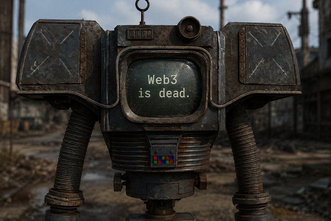 The image features a robot that says "Web3 is dead" written on its side. This message seems to be a statement or commentary about the current state of Web3, possibly related to cryptocurrency or blockchain technology. The robot appears to be made out of metal and has two arms extending from it. It's situated in an area with buildings visible in the background, suggesting that this scene might take place in an urban setting.