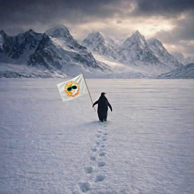 A penguin walking across a snowy landscape leaving footprints, carrying a white flag bearing a smiling sun wearing sunglasses, with snow-capped mountains in the background.