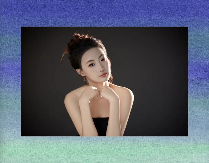 A studio portrait of a woman with her hair in a topknot resting her chin on her hands against a dark background, framed by a textured blue and green border.
