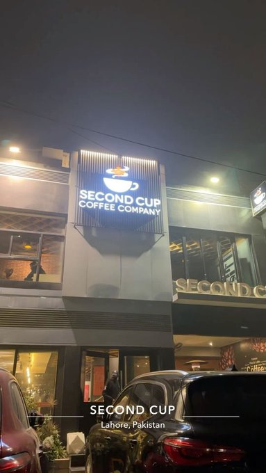 An exterior night shot of a Second Cup Coffee Company location in Lahore, Pakistan.