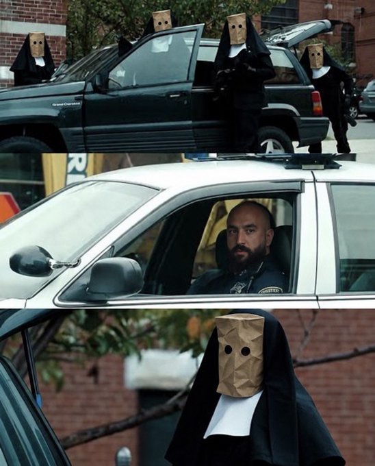 A meme featuring two panels: the top shows people in black robes and brown paper bags over their heads standing near vehicles, and the bottom shows a close-up of one of the bagged figures and a bearded officer sitting in a police car.