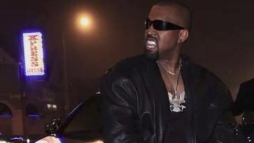 The image features a man wearing sunglasses, a leather jacket, and a necklace with a pendant. He appears to be posing for a photo or video, possibly at a club or event. The background includes a neon sign that reads "Xpress" and a building, suggesting an urban setting. A car is also visible in the image, parked behind the man. The post caption reads: "All aboard the Phoenix XPRess $XPR Peep the chain and sign".