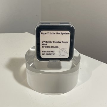 An Apple Watch displaying an NFT artwork titled 'Tape T Is In The System' by BLEAK, Q7 Entity Display Scope Mini by BARd IRonBun, Edition #10, AR+eReserve, displayed on a clear stand.