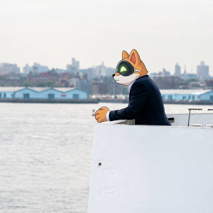 An animated illustration of an anthropomorphic orange cat wearing a black suit and green sunglasses, leaning on a white surface with a city skyline and water in the background.